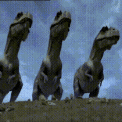 Three Dinosaurs Are Standing Next To Each Other In The Dirt GIF