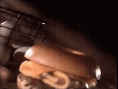 Three Donuts On Cutting Board With Knife GIF