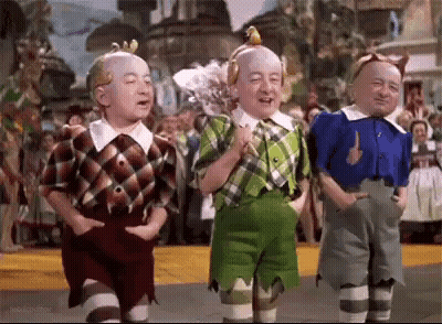 Three Dwarfs From The Wizard Of Oz Standing GIF