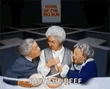Three Elderly Women Are Sitting At A Table Eating Food And Talking . GIF