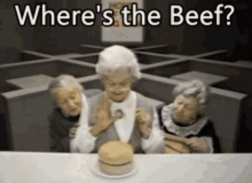 Three Elderly Women Are Sitting At A Table With A Hamburger And The Words " Where 'S The Beef " Written Above Them GIF