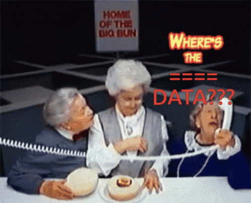 Three Elderly Women Are Sitting At A Table With A Sign That Says Home Of The Big Bun GIF