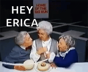 Three Elderly Women Are Sitting At A Table With A Sign That Says Home Of The Big Bun GIF