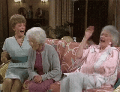 Three Elderly Women Are Sitting On A Couch Laughing And Waving Their Hands . GIF