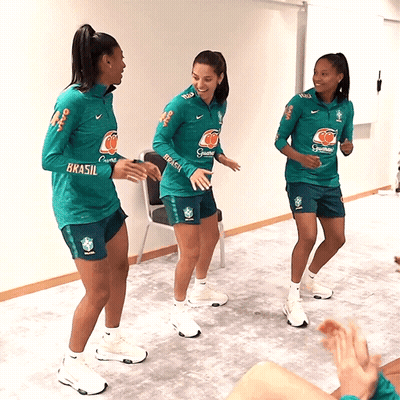 Three Female Athletes Wearing Green Shirts That Say Brasil Are Dancing Together GIF