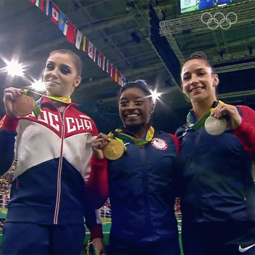 Three Female Gymnasts Are Posing For A Picture With One Wearing A Jacket That Says ' Dc Chg ' On It GIF
