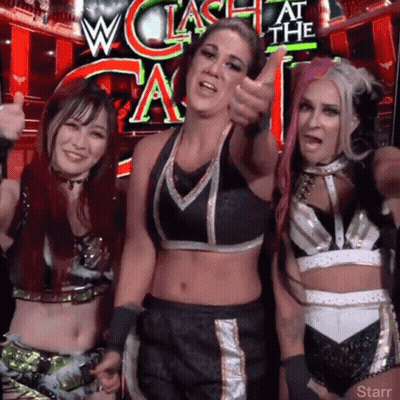 Three Female Wrestlers Posing in Front of W Clash At The A Sign