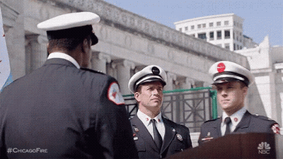 Three Firefighters Are Standing Next To Each Other In Front Of A Podium . GIF