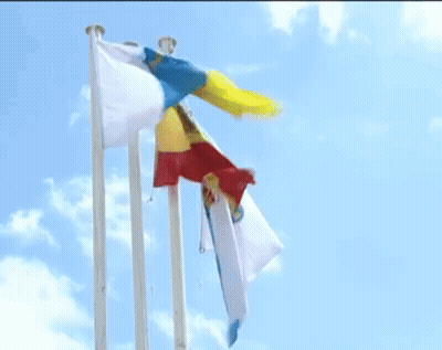 Three Flags Are Flying In The Wind Against A Blue Sky With Clouds GIF