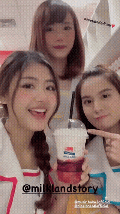 Three Girls Are Posing For A Picture With A Drink That Says Milklandstory On It GIF