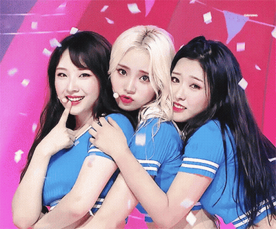 Three Girls Posing One In Blue Striped Shirt GIF