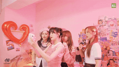 Three Girls Taking Selfie In Front Of Ali Magazine Wall GIF