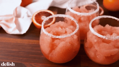 Three Glasses Filled With A Pink Liquid With The Word Delish On The Bottom GIF