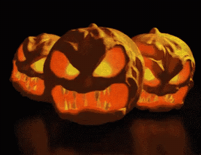 Three Glowing Pumpkins Lined Up GIF