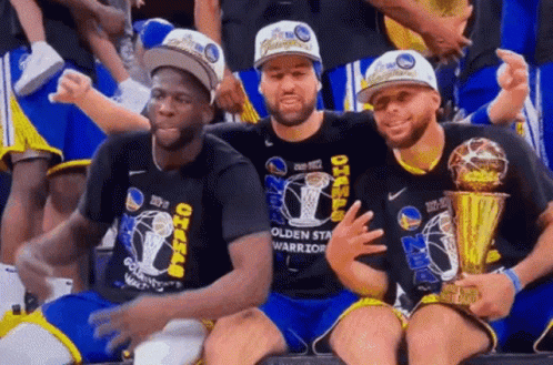 Three Golden State Warriors Players Are Posing For A Picture With Their Trophies . GIF