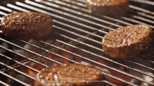 Three Hamburgers Cooking On Grill GIF
