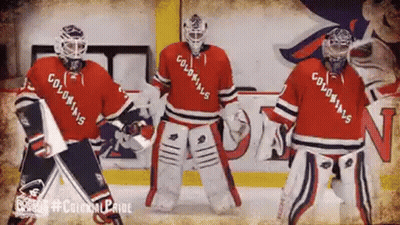 Three Hockey Players Wearing Colonials Jerseys Are Dancing On The Ice GIF