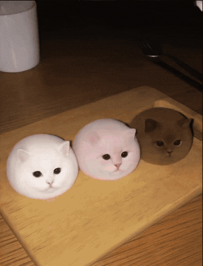 Three Marshmallow Cats On Wooden Cutting Board GIF