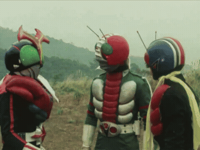 Three Masked Riders Standing In A Field GIF