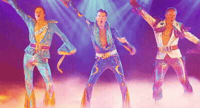 Three Men Are Dancing On A Stage And One Of Them Has The Word Sam On His Chest GIF