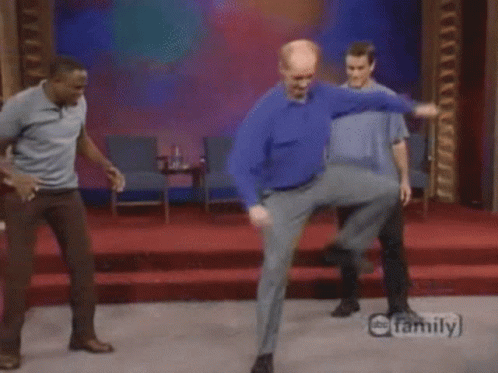 Three Men Are Dancing On A Stage In Front Of A Family Logo GIF