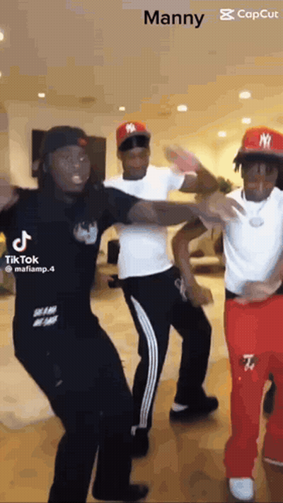 Three Men Are Dancing Together In A Room . GIF
