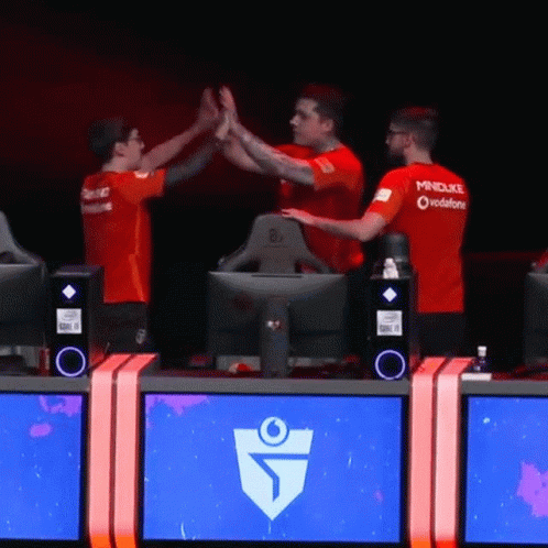 Three Men Are Giving Each Other A High Five While Wearing Red Mindduke Shirts GIF
