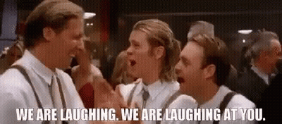 Three Men Are Laughing At Each Other In A Crowded Room . GIF