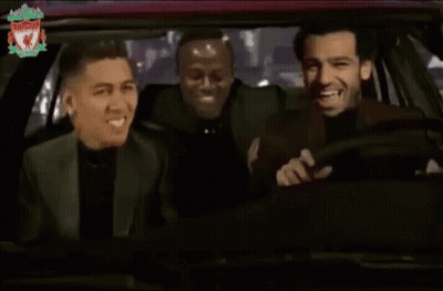 Three Men Are Laughing In A Car With The Liverpool Logo On The Bottom Right GIF