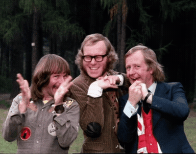 Three Men Are Posing For A Picture And One Of Them Has A Badge On His Jacket That Says ' A ' On It GIF