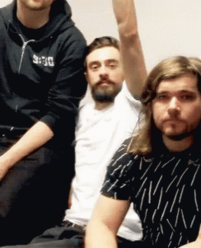 Three Men Are Posing For A Picture With One Wearing A Black Hoodie With The Word Deus On It GIF
