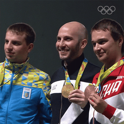 Three Men Are Posing For A Picture With One Wearing A Jacket That Says Ea7 On It GIF