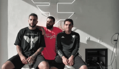 Three Men Are Posing For A Picture With One Wearing A T-Shirt That Says " Fate Clan " GIF