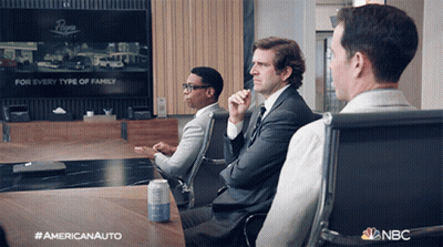 Three Men Are Sitting At A Table With A Can Of Soda On It And A Nbc Logo In The Corner GIF
