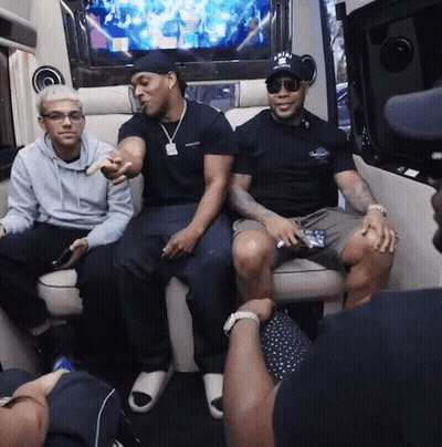 Three Men Are Sitting In A Van And One Of Them Is Wearing A Hat That Says A & A On It GIF