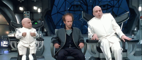 Three Men Are Sitting In Chairs And One Of Them Has A Bald Head GIF