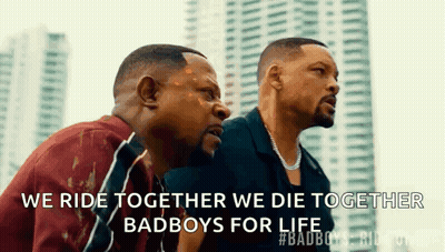 Three Men Are Sitting Next To Each Other In Front Of A City Skyline . GIF