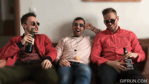 Three Men Are Sitting On A Couch Holding Bottles Of Jack Daniels Whiskey GIF