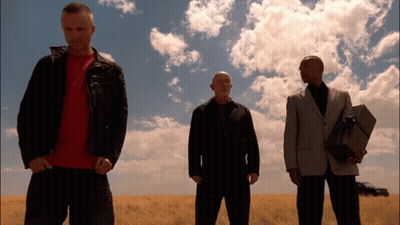 Three Men Are Standing In A Field And One Is Holding A Gift Box GIF