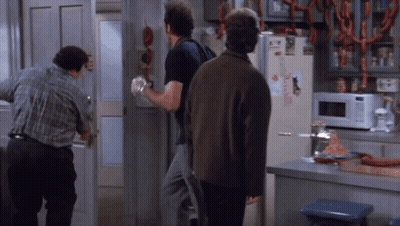 Three Men Are Standing In Front Of A Refrigerator That Has A Sticker On It That Says ' A ' On It GIF