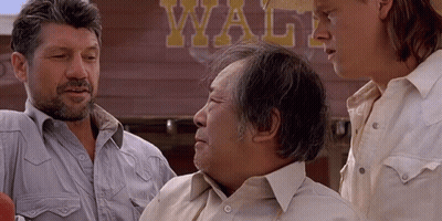 Three Men Are Standing In Front Of A Sign That Says Waltz GIF