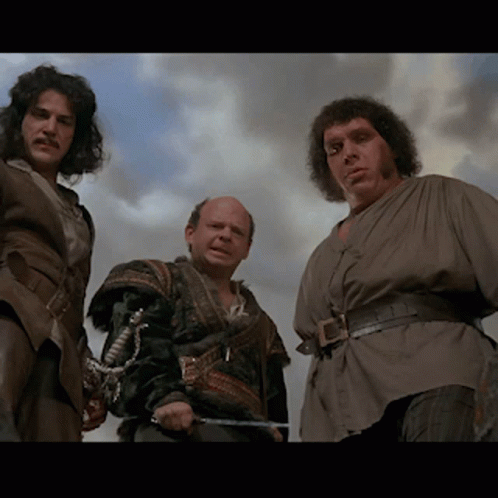 Three Men Are Standing Next To Each Other And One Has A Sword GIF