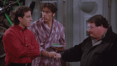 Three Men Are Standing Next To Each Other And One Of Them Is Holding A Remote Control GIF
