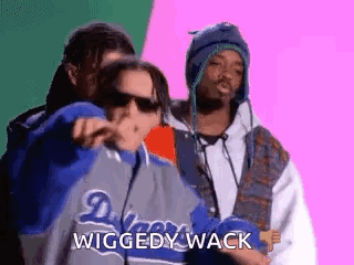 Three Men Are Standing Next To Each Other And One Of Them Is Pointing At The Camera . GIF