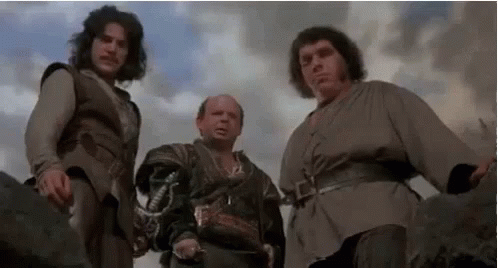 Three Men Are Standing Next To Each Other In A Field Holding Swords . GIF