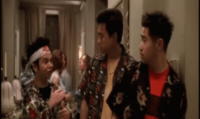 Three Men Are Standing Next To Each Other In A Room And One Of Them Has A Bandana On His Head . GIF