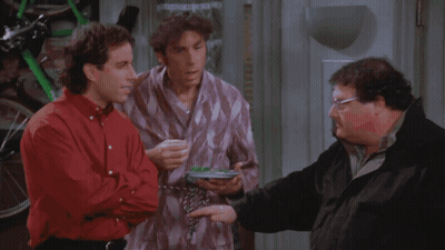 Three Men Are Standing Next To Each Other In A Room And One Of Them Is Holding A Frisbee GIF