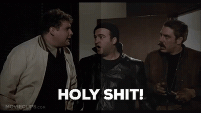 Three Men Are Standing Next To Each Other In A Room And One Of Them Is Holding A Gun And Saying Holy Shit . GIF