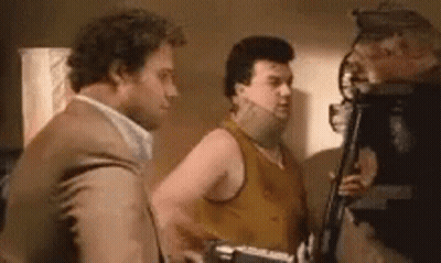 Three Men Are Standing Next To Each Other In A Room And Talking To Each Other . GIF