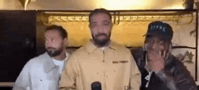 Three Men Are Standing Next To Each Other In A Room . GIF